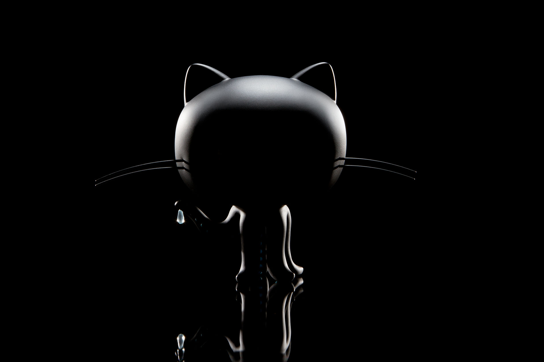 Dramatically back-lit silhouette image of the Octocat figurine